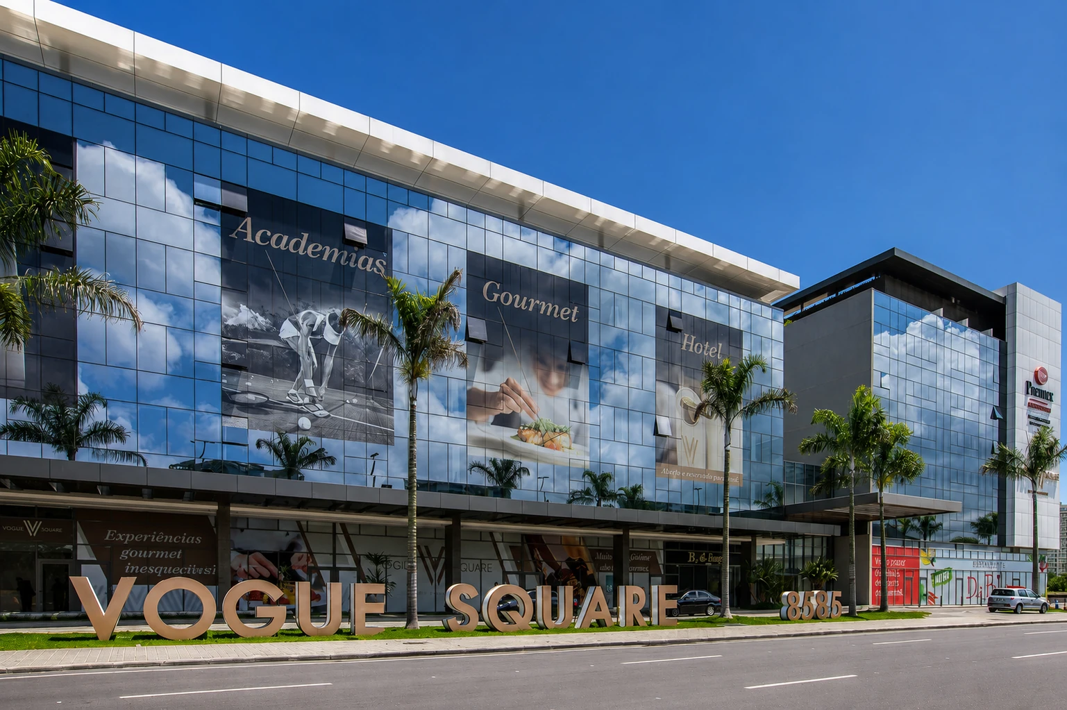 Fachada do Vogue Square na Barra da Tijuca — letreiro do empreendimento na entrada, com palmeiras e céu azul